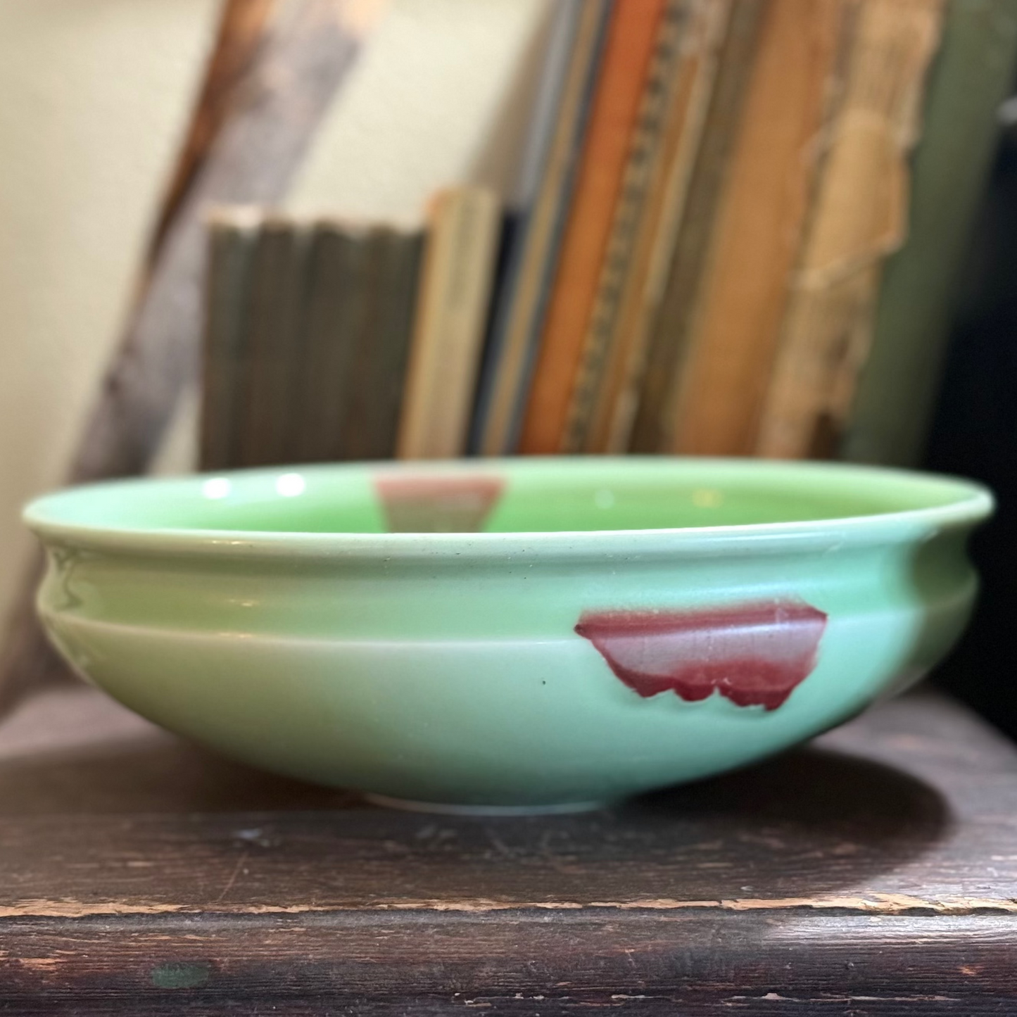 Green glass bowl with a brown fleck resembles Jade.