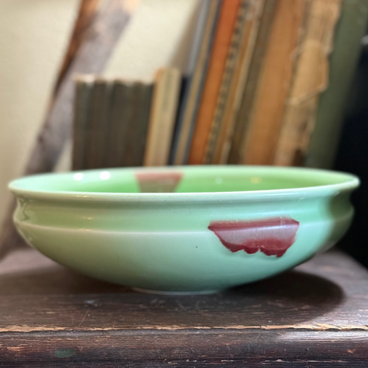 Green glass bowl with a brown fleck resembles Jade.