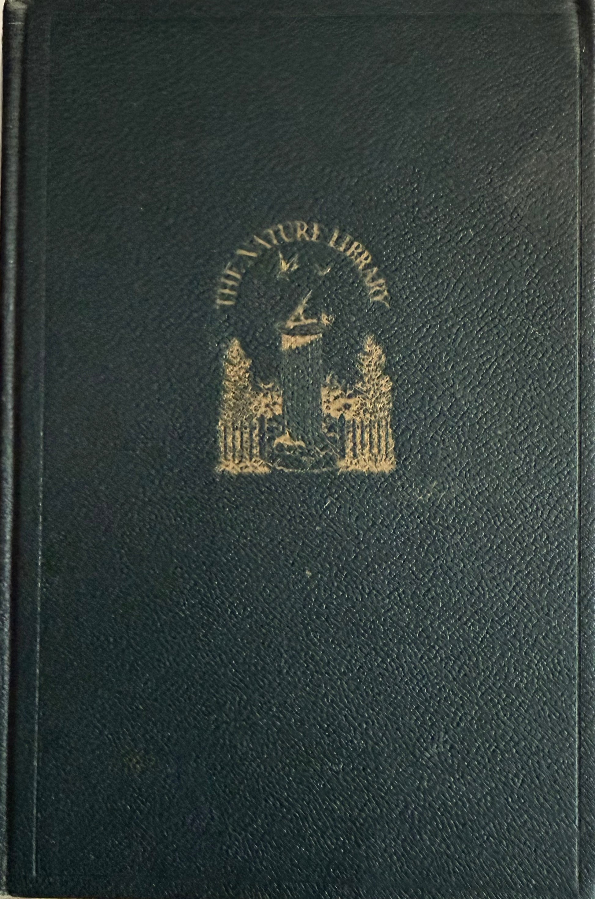 A dark green textured leather-bound book with gold foil embossed lettering reading 'THE NATURA LIBRARY' and a crest emblem on the front cover. topic Garden Flowers