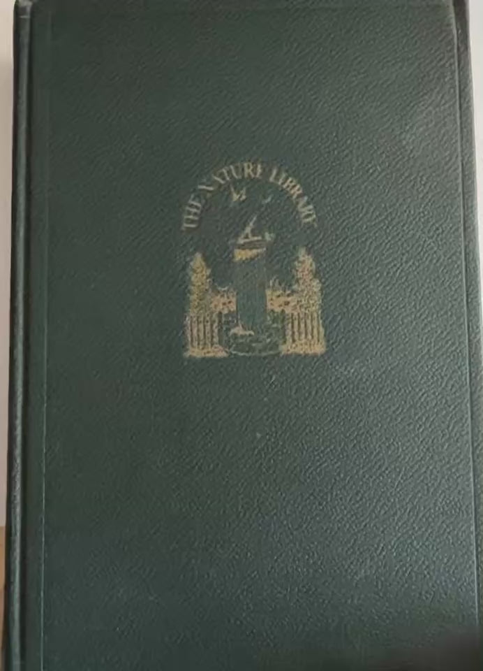 Video flip-through of Garden Flowers by McCurdy from The Nature Library series, showing the antique leather-bound cover with gold-stamped sundial and garden emblem